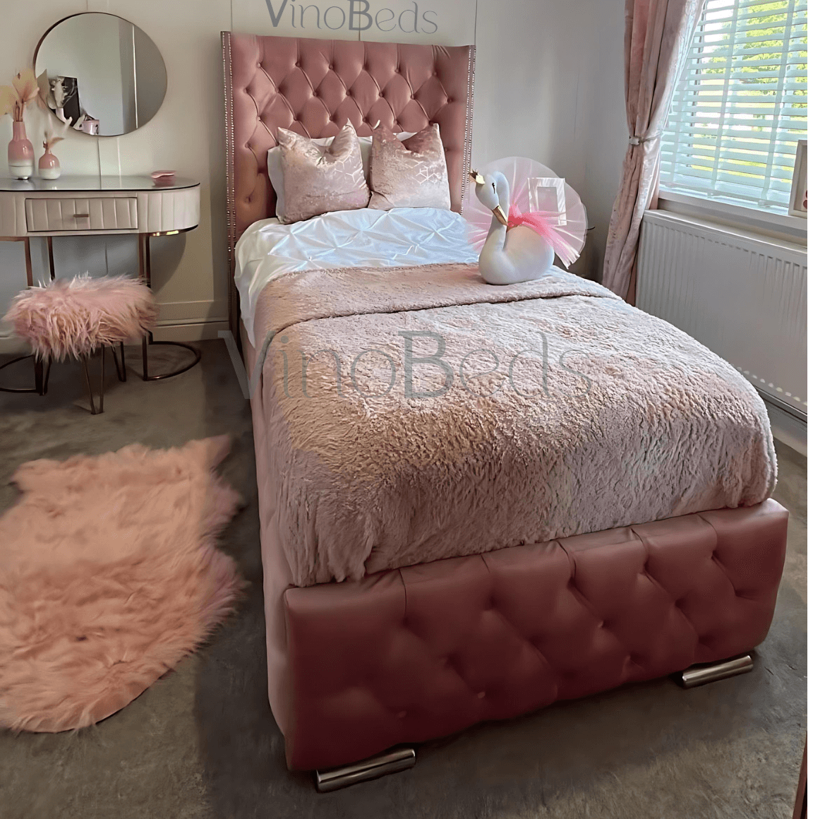 Close-up of the Burby Bed’s tufted pink headboard, showcasing detailed stitching and luxurious texture